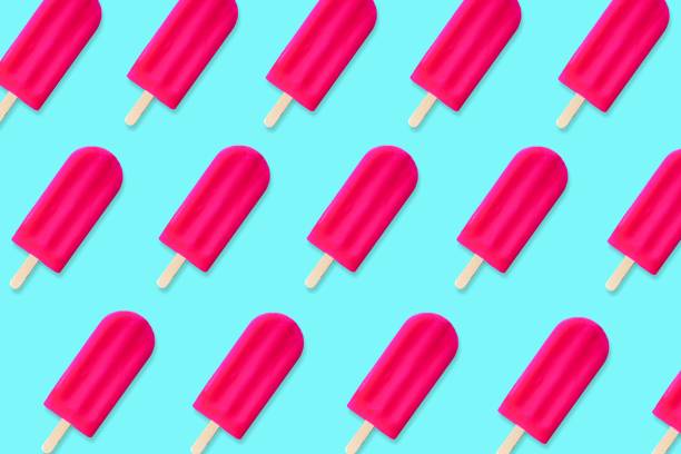 istock Summer pattern of pink popsicles on a blue background 965187972