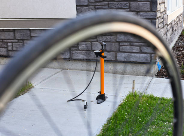 Close up and selective focus of a bicycle tire pump used to inflate the bicycle's tire after a puncture repair job.