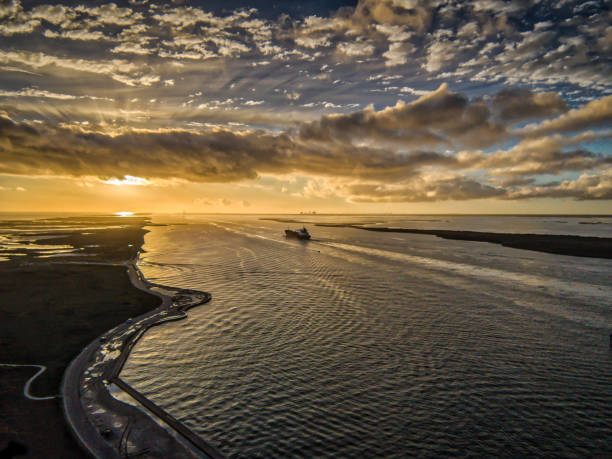 Aerial photo taken over the Intercoastal Waterway on the Texas Gulf Coast of a tanker ship headed towards Corpus Christi, Texas during sunset.