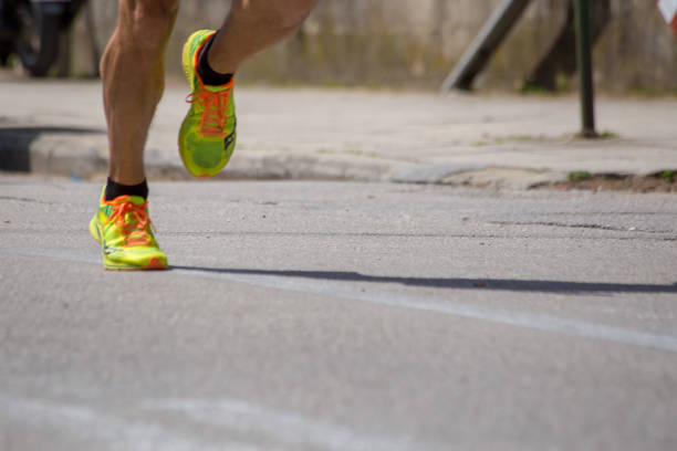 istock runnesr feet back race on asphalt action , background 965204240