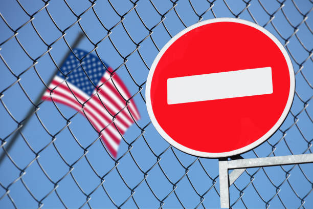 istock US flag behind the fence with the sign is forbidden 965217872
