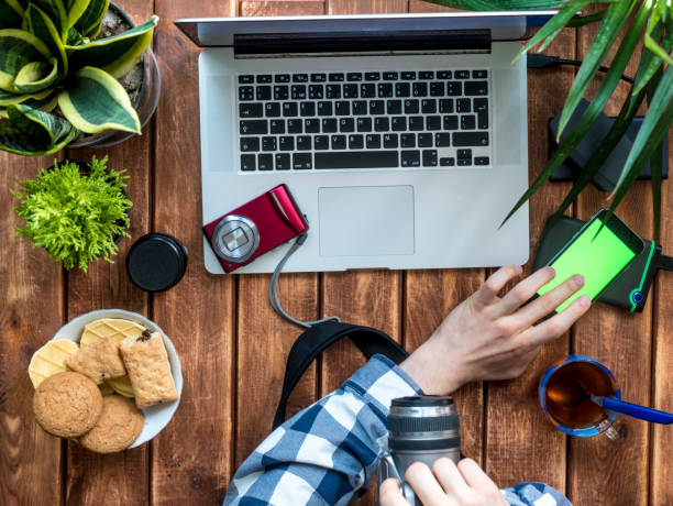 istock photographer working at home with camera and smartphone 965220806