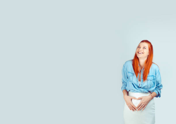 istock Loving woman in expectancy holding hands on belly 965221148