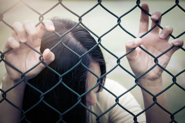 istock Depressed, trouble and solution. Hopeless women hand on chain-link fence. 965233828