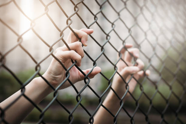 istock Depressed, trouble and solution. Women hand on chain-link fence. 965235906