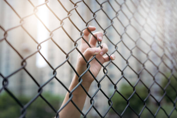 istock Depressed, trouble and solution. Women hand on chain-link fence. 965235934