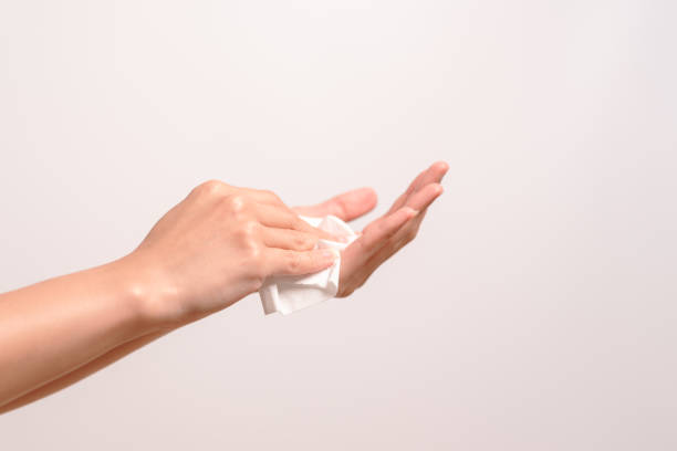 istock Woman cleaning her hands with white soft tissue paper. isolated on a white backgrounds 965243678