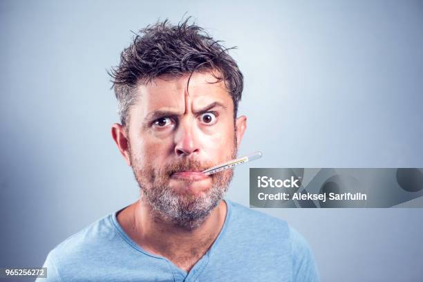 Sick Man With Thermometer In Mouthlooking And Worry At Thermometer On White Backgroundhealthcare Concept Stock Photo - Download Image Now