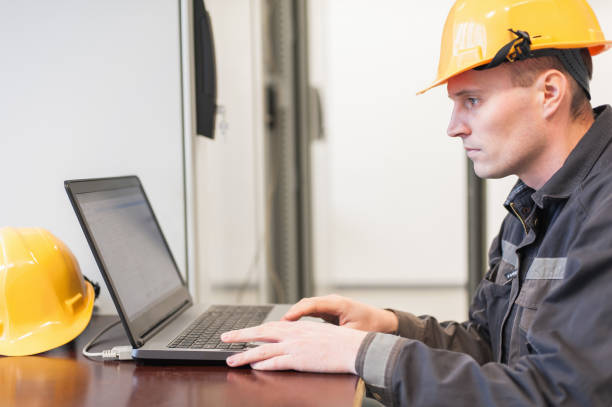 istock Field service engineer inspect relay protection system with laptop comput 965267050