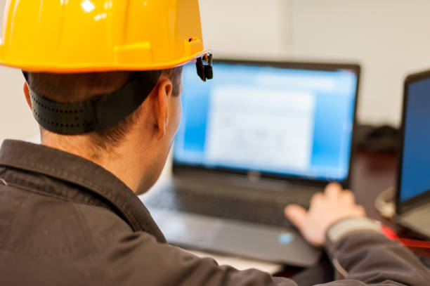 Field service engineer inspect relay protection system with laptop comput