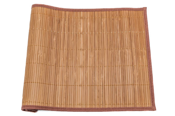 istock Bamboo mat on white background, close-up, tucked on one side. Isolated. 965282320