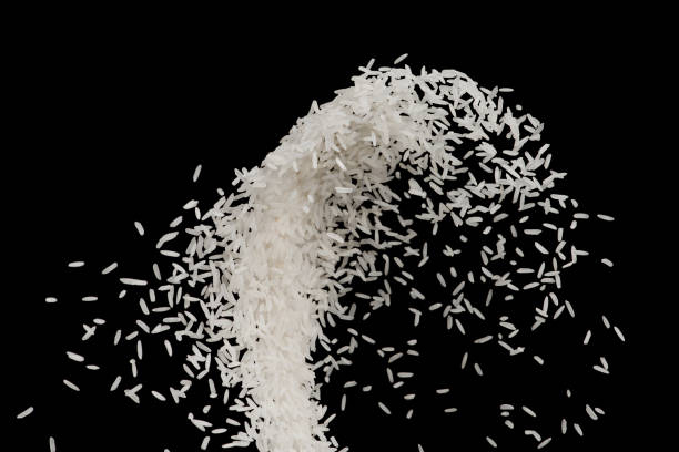 istock Stop motion raw white rice launch in the air  isolated on black background food object design 965293714