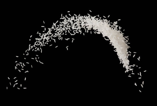 istock Stop motion white rice splash or explode flying in the air  isolated on black background food object design 965296622