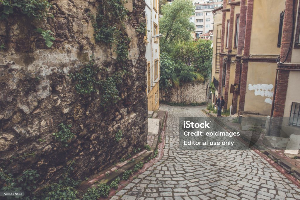 Vintage view of Traditional street and houses  at balat area People walking at Traditional street of  balat area.Street view in historical Balat district. Balat is popular attraction in Istanbul Alley Stock Photo