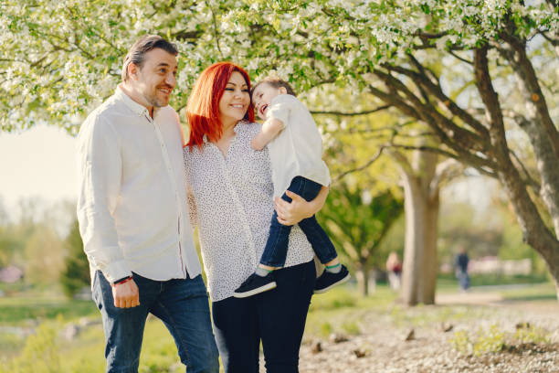 istock cute family in a sunny park 965331440
