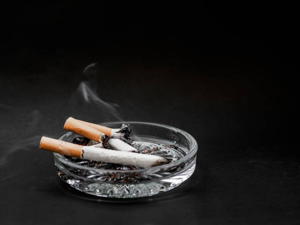 istock Cigarette in the ashtray on a black background. TOBACCO. 965331498