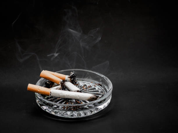 istock Cigarette in the ashtray on a black background. TOBACCO. 965331504