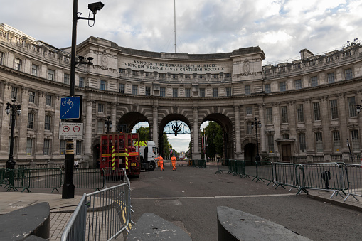 London - July 30, 2017: Two workers standing in front of Admiralty Arch in London.