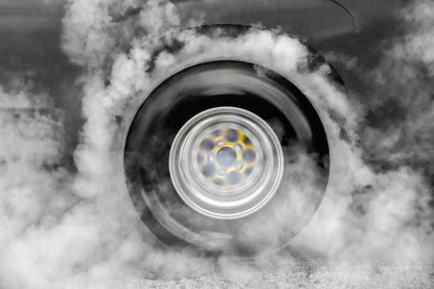 istock Drag racing car burn tire at start line 965346010