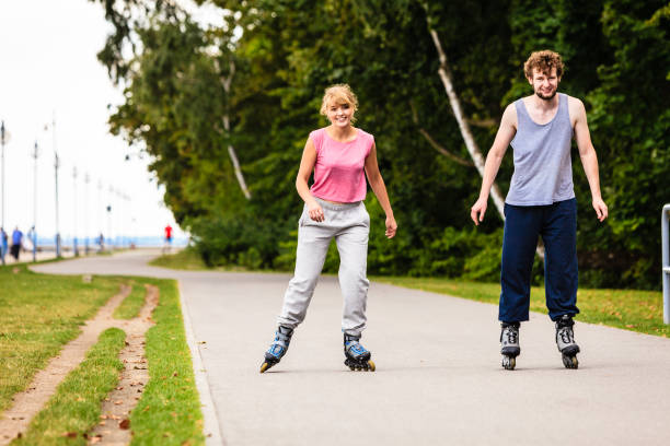 istock Active young people friends rollerskating outdoor. 965348734