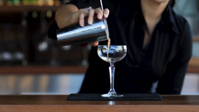 Female Bartender Making Cocktails