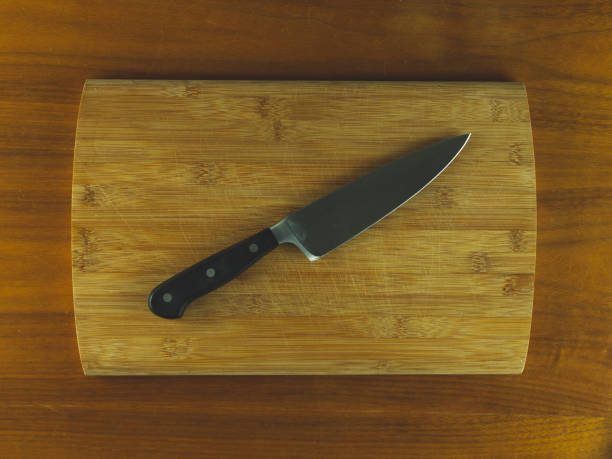 istock Wooden cutting board with a diagonal knife 965369772