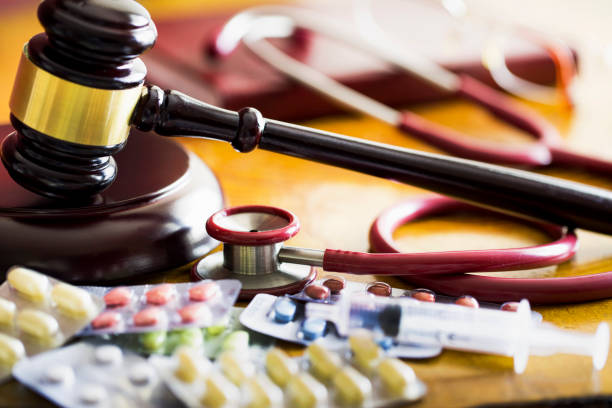 Drug law concept. Judges gavel with  stethoscope  and pills close up stock photo