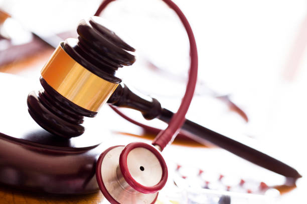 Medicine law concept. Judges gavel with  stethoscope  and pills close up stock photo