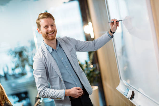 istock Attractive young businessman doing presentation in office 965384576
