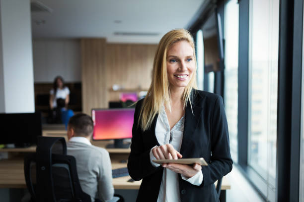 istock Attractive businesswoman using digital tablet in office 965384746