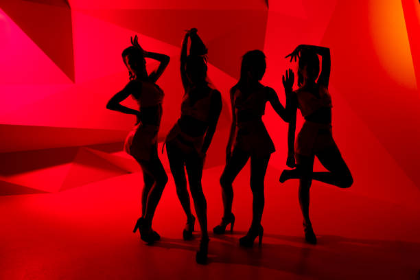 Photo of silhouettes of four sexy posturing girls in red light Photo of silhouettes of four sexy posturing girls in red light seductive women stock pictures, royalty-free photos & images