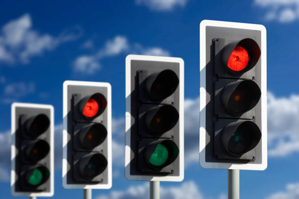 istock FOUR TRAFFIC LIGHTS SHOWING GREEN AND RED 965387978