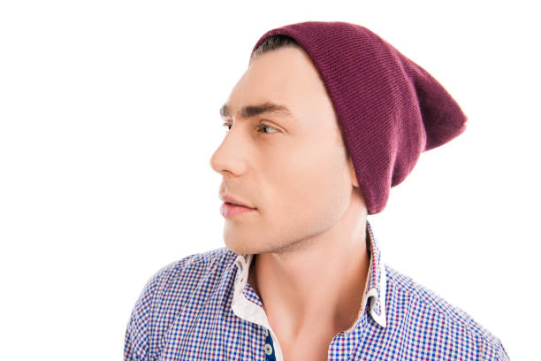 istock Handsome young man in violet cap, side face photo 965394326