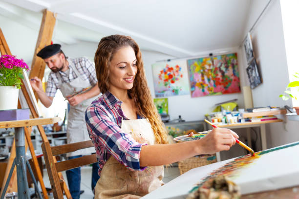istock Fine art painters working in atelier together 965403754
