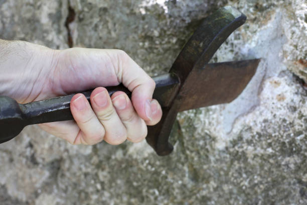 istock hand of kinight and the Magical Excalibur sword 965404578