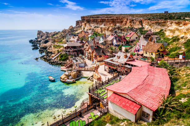 Malta, Il-Mellieha - Popeye village Malta, Il-Mellieha. View of the famous village Mellieha and bay on a sunny day malta photos stock pictures, royalty-free photos & images