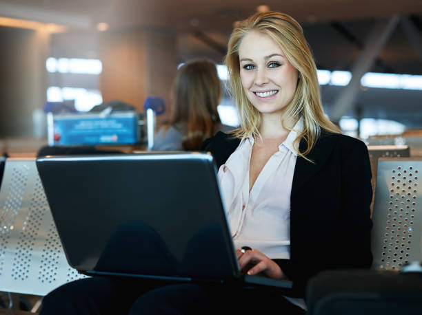 istock Woman working on laptop computer at airport 965408168