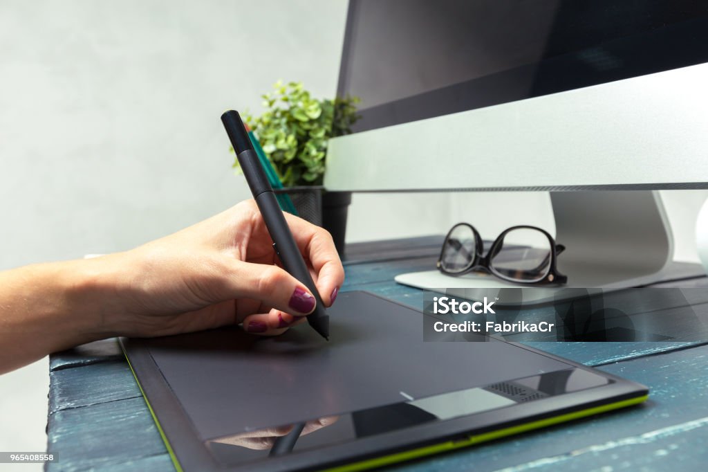 Hand of graphic designer working with stilus and tablet Accuracy Stock Photo