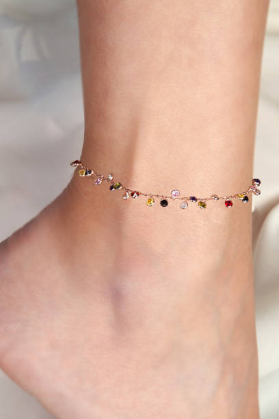 istock Young Woman Wearing Rose Gold Colored Silver Anklet with Stones 965408994