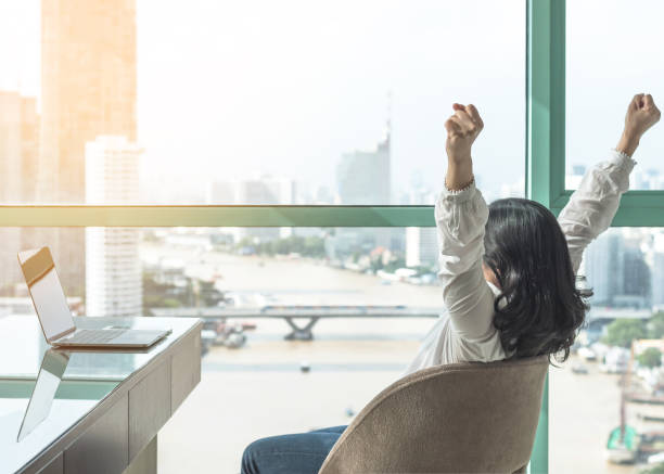 istock Work done, life balance and success celebration concept with happy woman take it easy casually resting in luxury business hotel or at home office workplace with computer pc laptop on desk 965412652