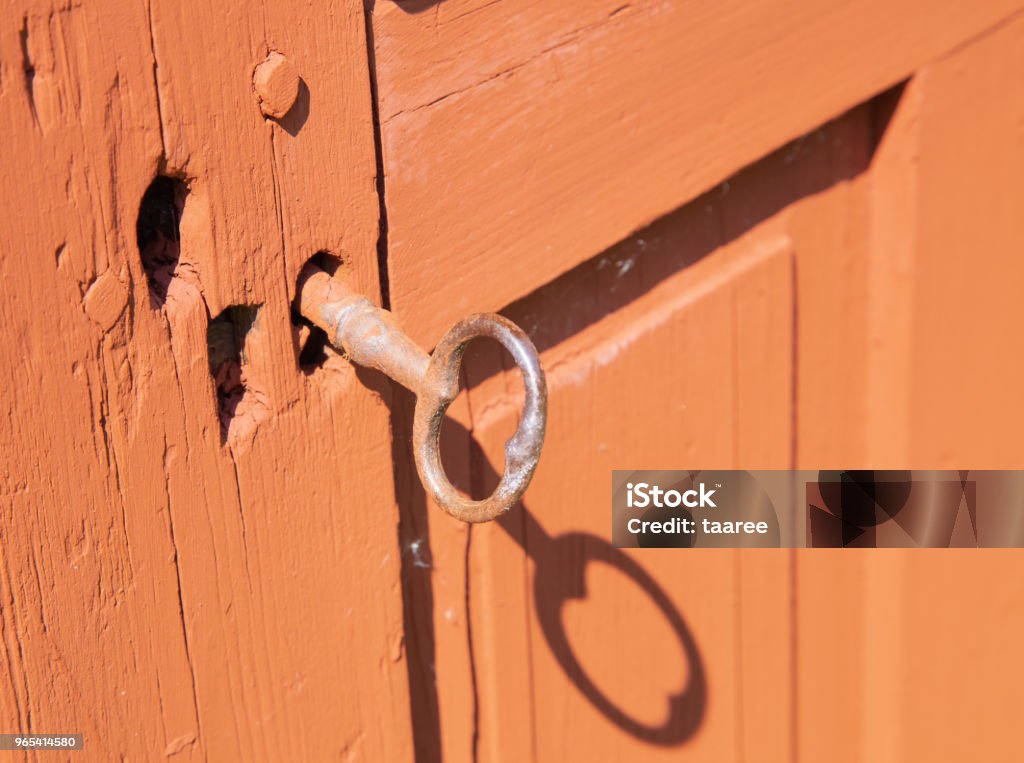 Key Old rusty key with old red door Antique Stock Photo