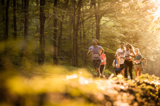 istock Below view of athletic people running a marathon through nature. 965417052