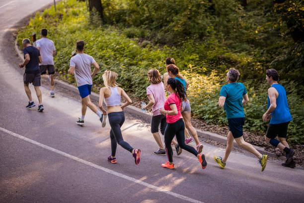 istock Above view of competitive group of athletes running a marathon. 965420792