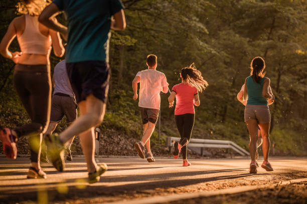 istock Rear view of runners during marathon race at sunset. 965420962
