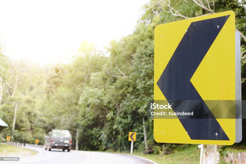 Yellow curve traffic sign on the road Advice Stock Photo