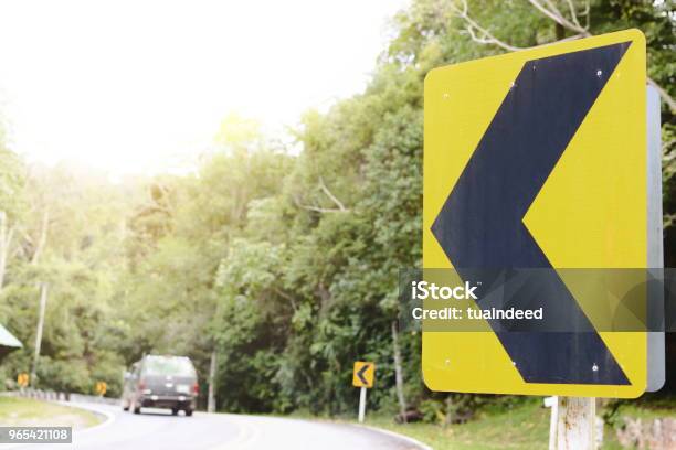 Yellow Curve Traffic Sign On The Road Stock Photo - Download Image Now - Advice, Alertness, Arrow Symbol