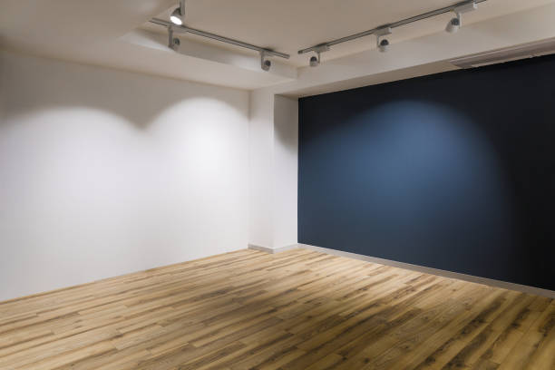 istock Empty room with dark and white walls and wooden floor 965421414