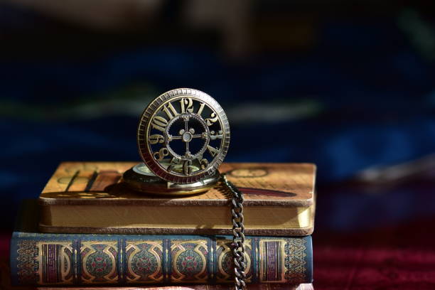 istock Old pocket watch and books 965421444