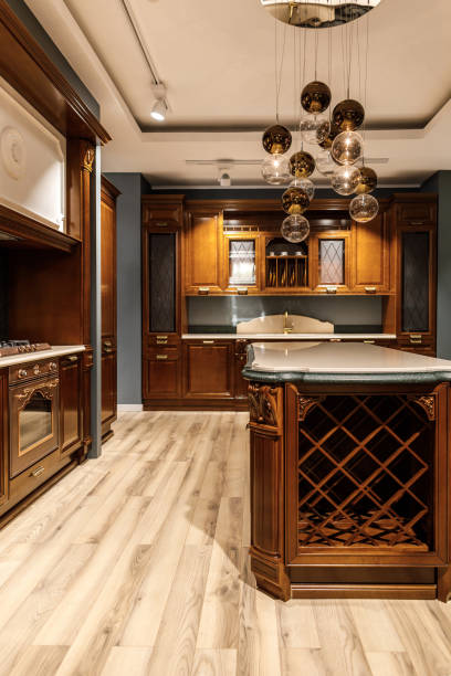 istock Stylish kitchen with large wooden counter and chandelier 965421630