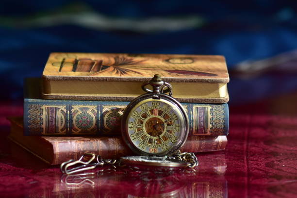 istock Old pocket watch and books 965421728